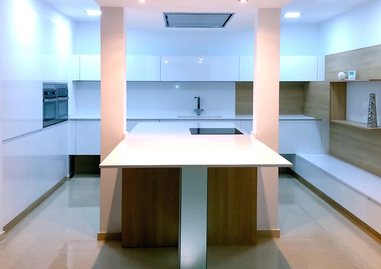 Cocina con encimera blanca de 2cm de espesor. La tendencia para este año 2018 se inclina claramente hacia las encimeras finas.