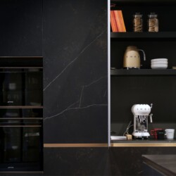 Composición de muebles columna modelo FUSSION acabado cerámica KELYA con pequeños electrodomésticos en el interior Composición de muebles columna en acabado cerámica con mueble abierto que contiene pequeños electrodomésticos de cocina y otros elementos.